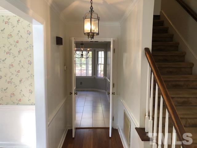 2804 Steeplechase Court Raleigh, NC 27613 - Photo 8 of 41 a view of a hallway with wooden floor and staircase