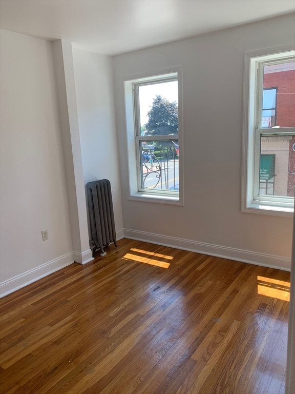 10 Yeamans Street, Unit 17 Revere, MA 02151 - Photo 6 of 8 a view of empty room with wooden floor and fan