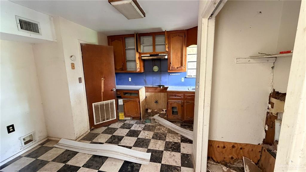 1524 West Hi Line Road Pharr, TX 78577 - Photo 28 of 34 a room with wooden cabinets and black appliances
