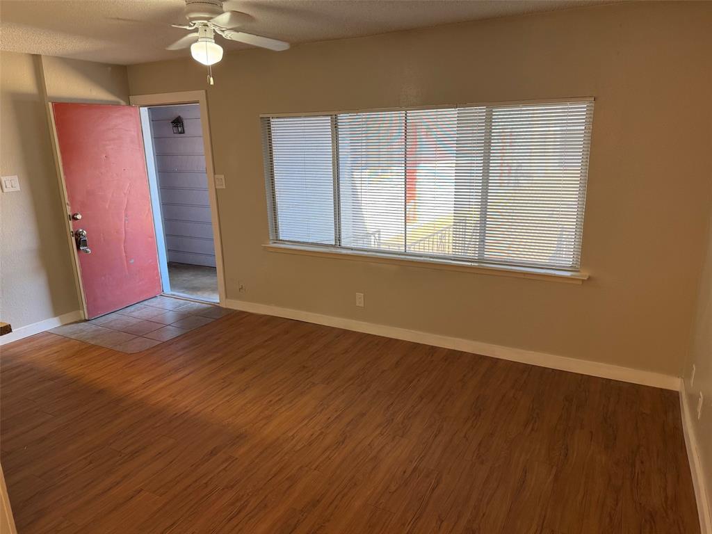 2408 Longview Street, Unit 108 Austin, TX 78705 - Photo 4 of 7 a view of an empty room with wooden floor and a window