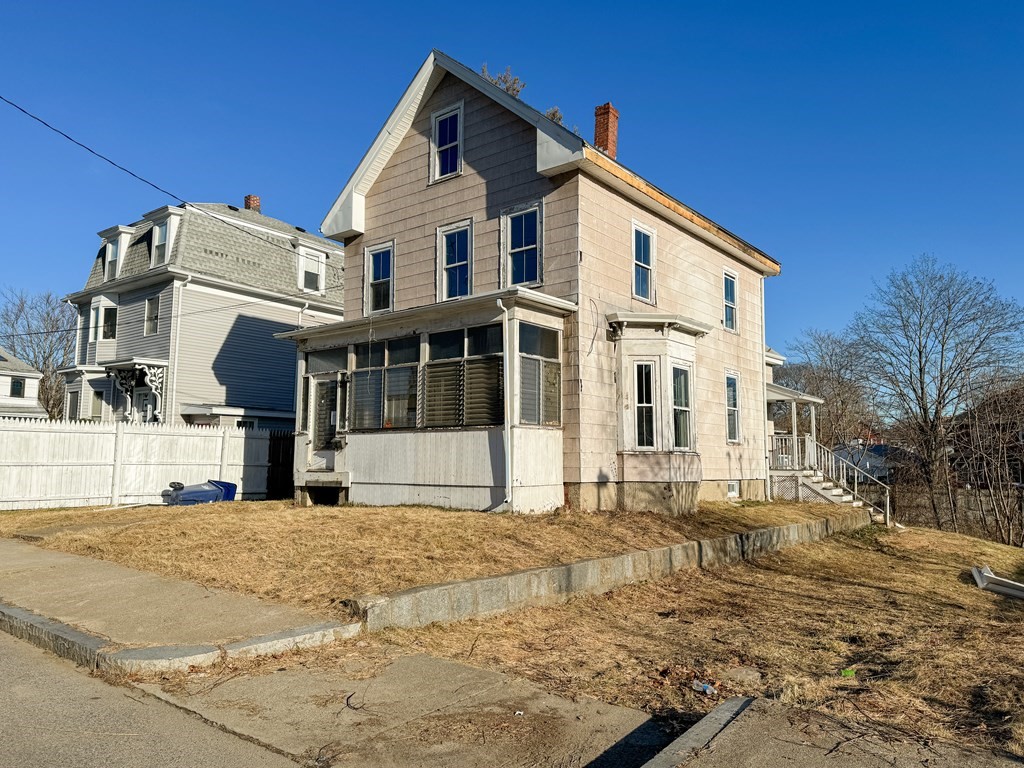 64 Braeburn Road Boston, MA 02136 - Photo 4 of 23 a view of a white house with a large windows next to a road