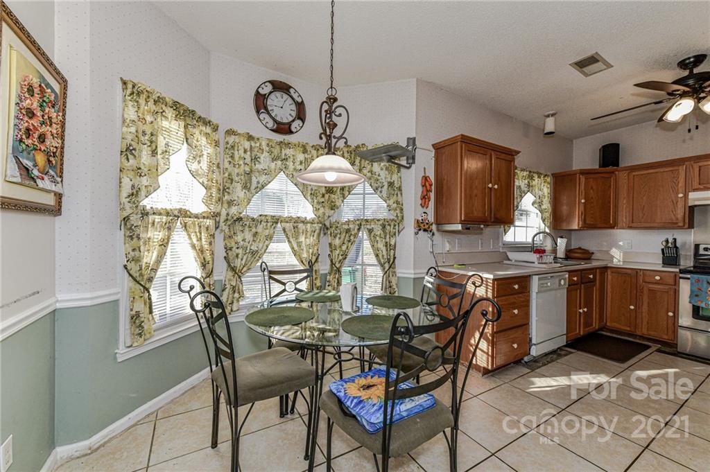 9043 Silver Coach Lane Charlotte, NC 28273 - Photo 11 of 32 a view of a dining room with furniture and chandelier