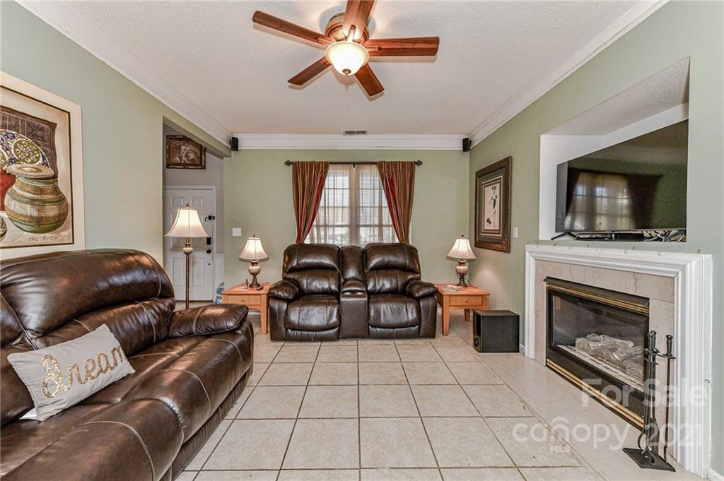 9043 Silver Coach Lane Charlotte, NC 28273 - Photo 13 of 32 a living room with furniture and a fireplace