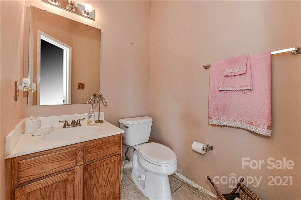 9043 Silver Coach Lane Charlotte, NC 28273 - Photo 16 of 32 a bathroom with a granite countertop toilet sink and mirror