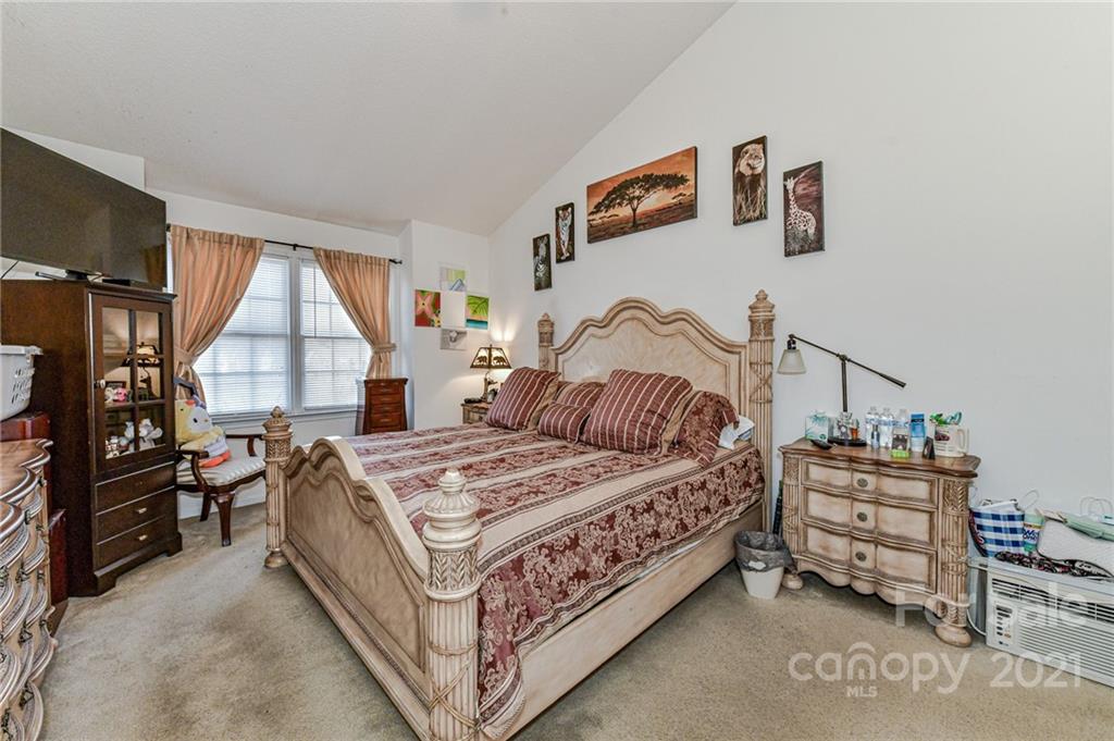 9043 Silver Coach Lane Charlotte, NC 28273 - Photo 19 of 32 a bedroom with a bed next to a window
