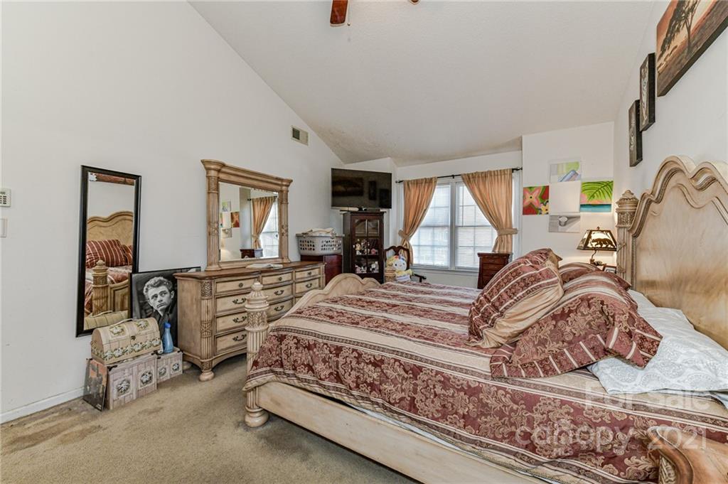 9043 Silver Coach Lane Charlotte, NC 28273 - Photo 20 of 32 a bedroom with a bed and wooden floor