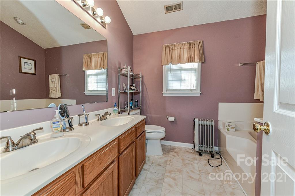 9043 Silver Coach Lane Charlotte, NC 28273 - Photo 21 of 32 a bathroom with a sink double vanity and tub