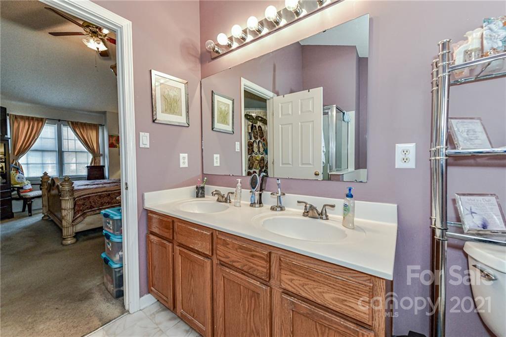 9043 Silver Coach Lane Charlotte, NC 28273 - Photo 22 of 32 a en suite bathroom with a sink double vanity and a mirror