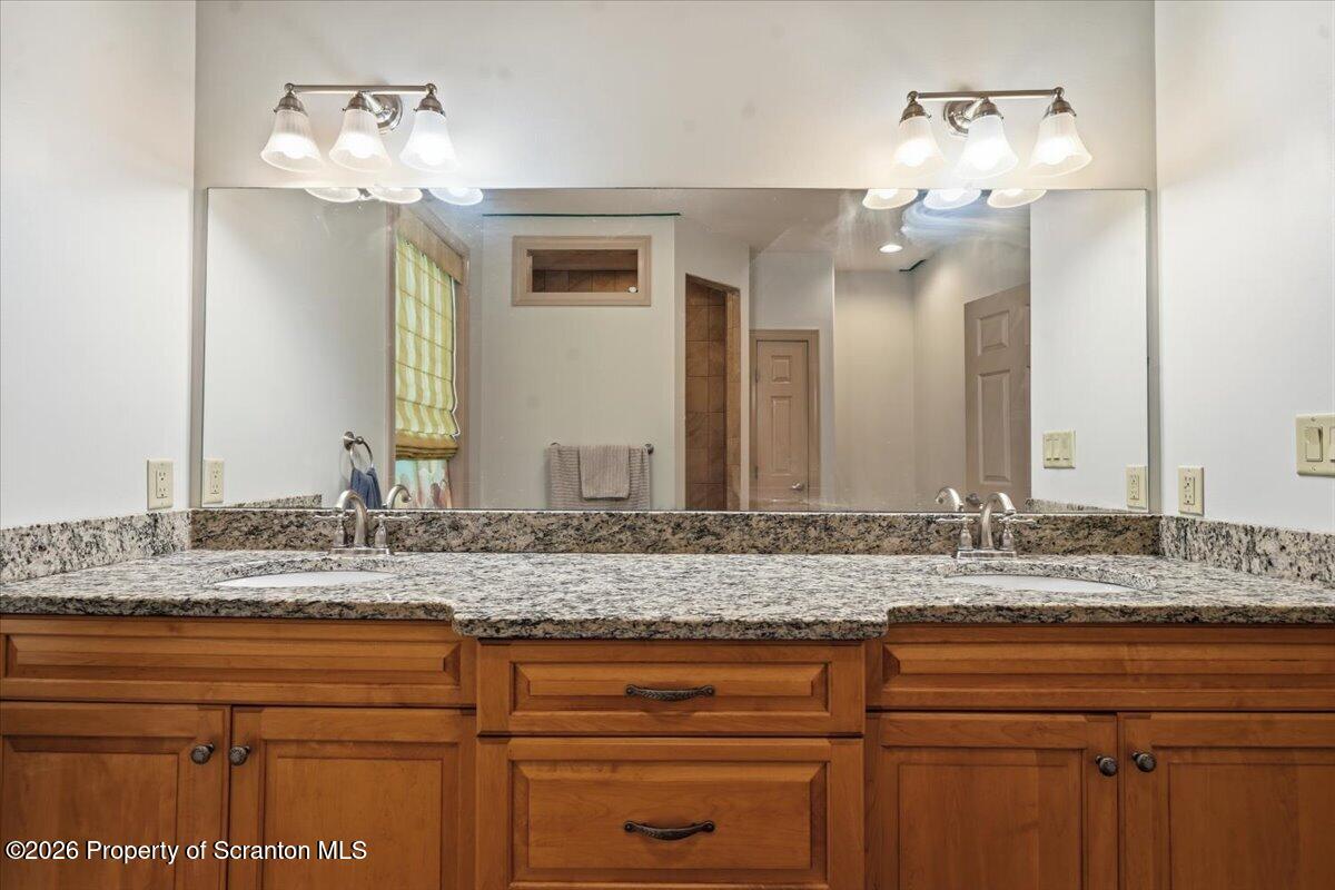99 Hilltop Road Waverly, PA 18471 - Photo 30 of 41 a bathroom with a sink and a mirror