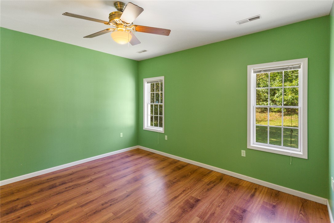 621 Burns Mill Road West Union, SC 29696 - Photo 12 of 45 A vibrant room featuring rich wood flooring and a refreshing view of the outdoors.