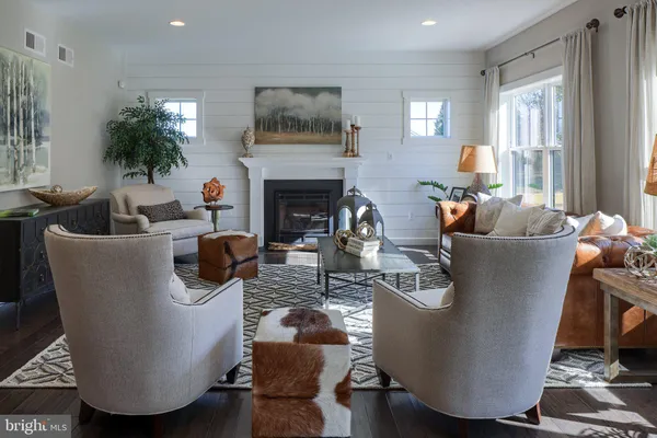 a living room with furniture a chandelier and a fireplace