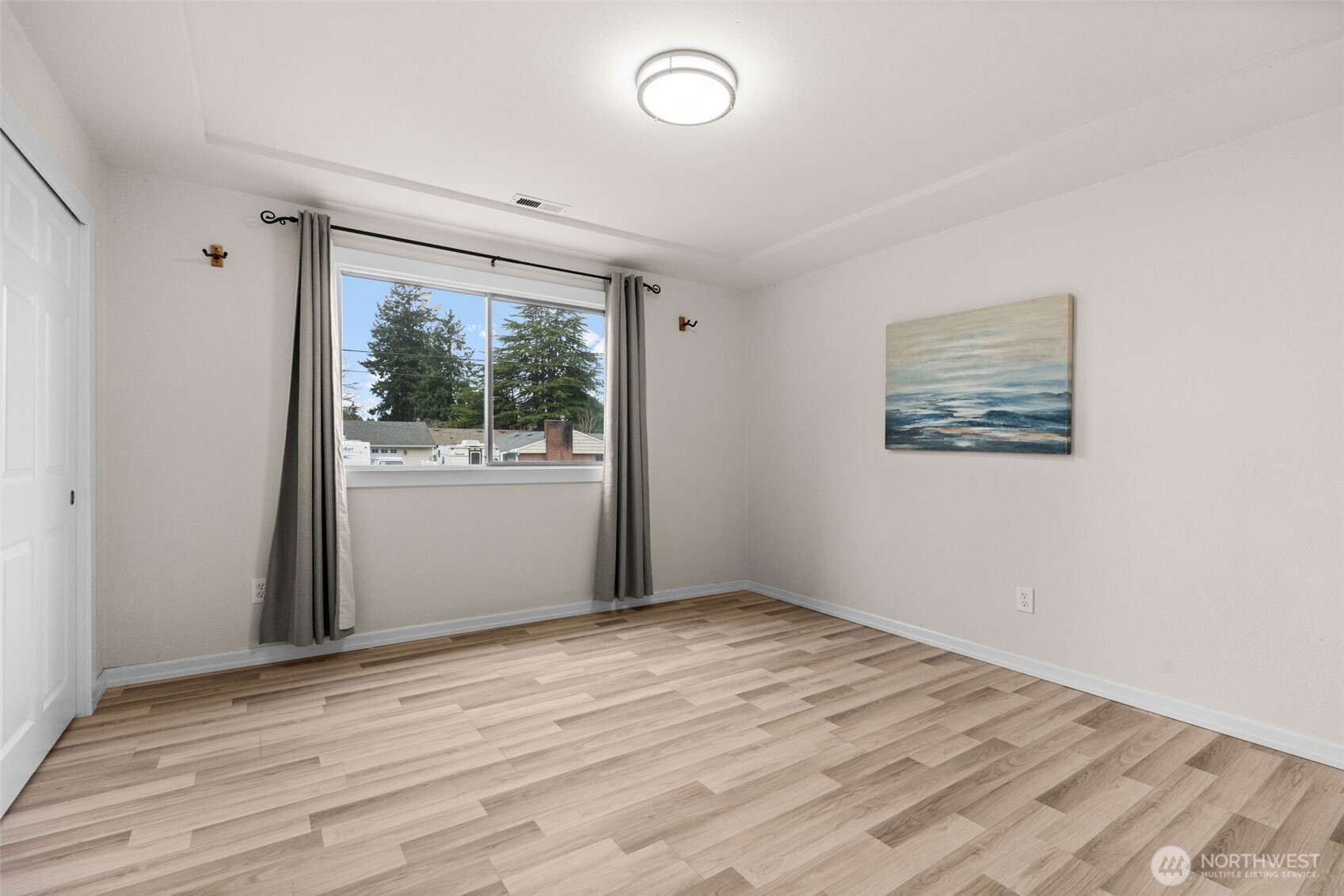 3215 North Tyler Street Tacoma, WA 98407 - Photo 17 of 40 an empty room with wooden floor and windows