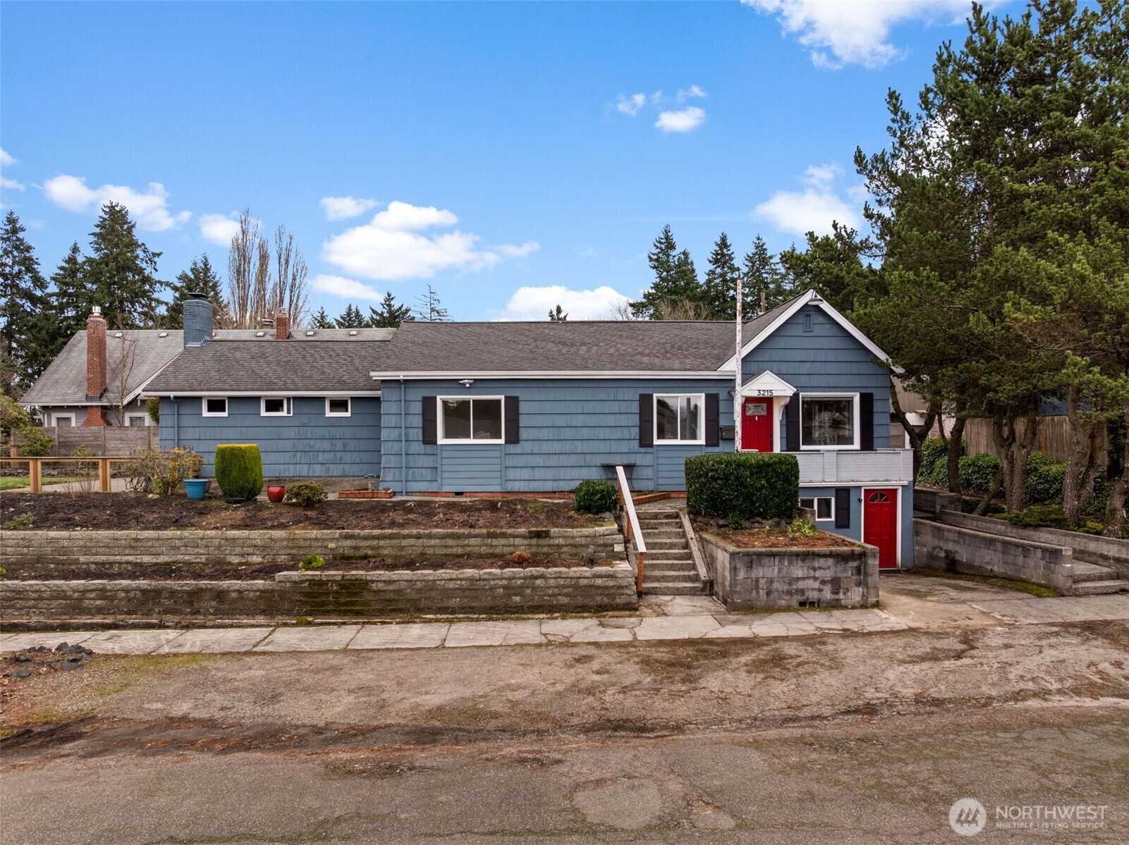3215 North Tyler Street Tacoma, WA 98407 - Photo 2 of 40 a front view of a house with a yard