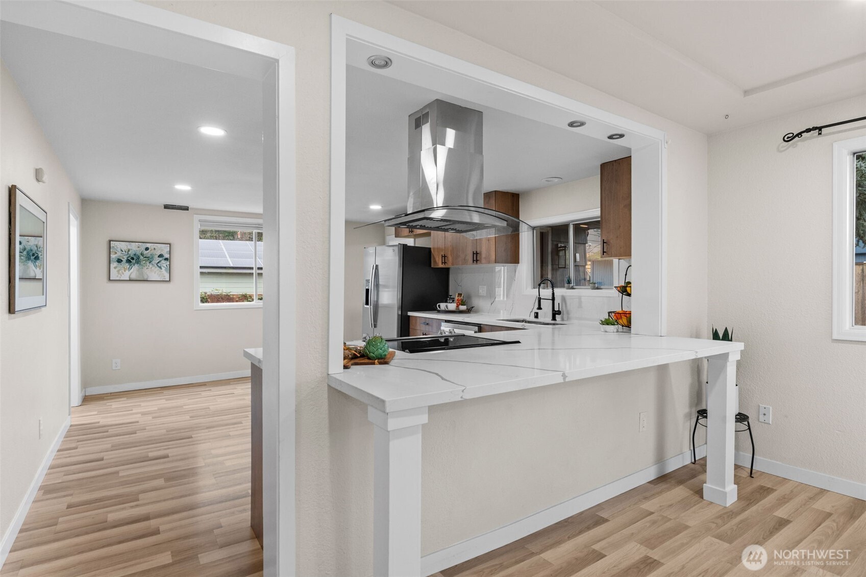 3215 North Tyler Street Tacoma, WA 98407 - Photo 6 of 40 a view of a kitchen counter top space with stainless steel appliances wooden floor and view living room