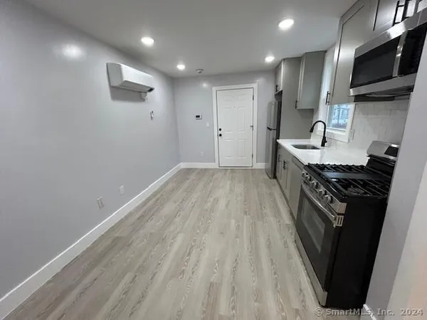 a kitchen with a sink stainless steel appliances and cabinets