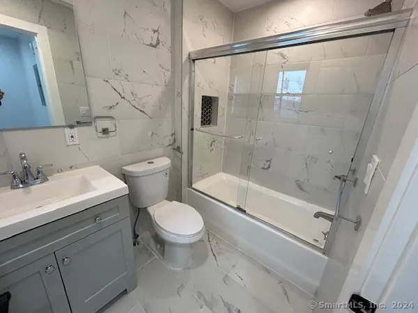 a bathroom with a sink toilet and shower