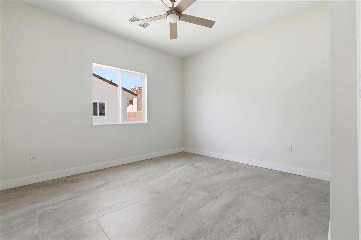 68160 Modalo Road Cathedral City, CA 92234 - Photo 45 of 57 an empty room with a window and a fan