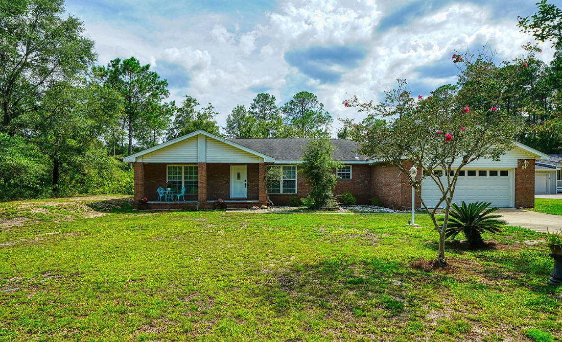 868 Mallet Bayou Road Freeport, FL 32439 - Photo 1 of 69 a front view of a house with garden