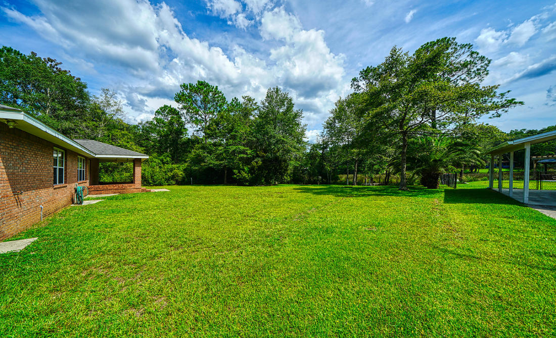 868 Mallet Bayou Road Freeport, FL 32439 - Photo 44 of 69 a front view of house with a garden