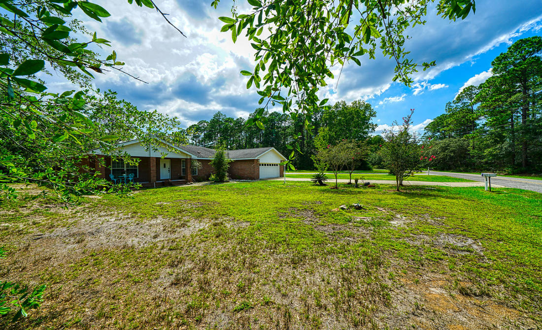 868 Mallet Bayou Road Freeport, FL 32439 - Photo 8 of 69 a front view of a house with a yard