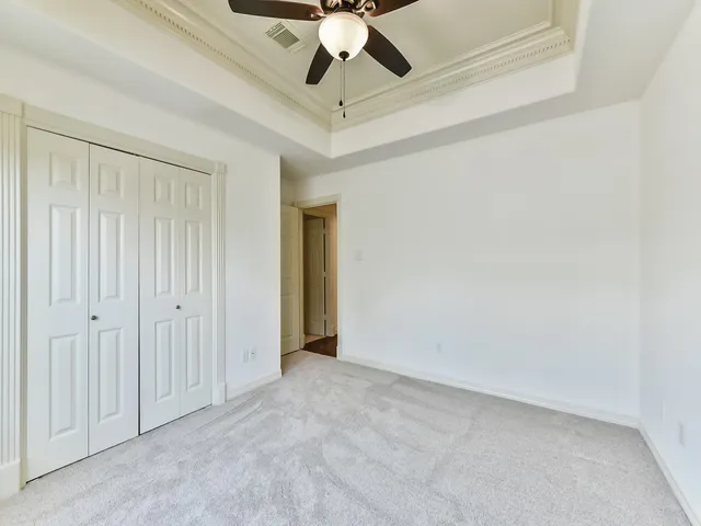 a view of a cabinet and a chandelier fan in a room