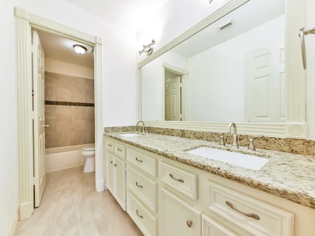 an empty room with cabinet and ceiling fan