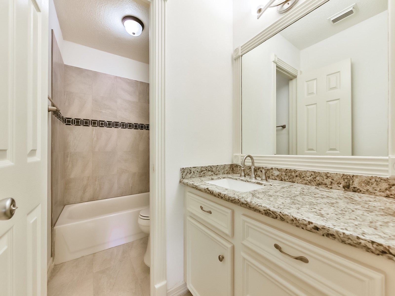 166 East Capstone Circle Spring, TX 77381 - Photo 42 of 45 a bathroom with a granite countertop sink and a mirror