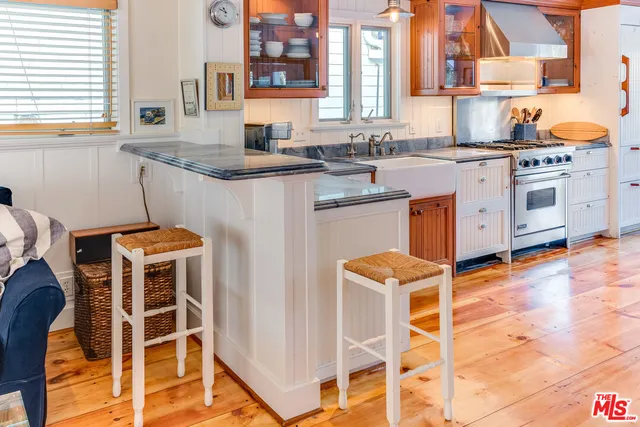 a kitchen with a stove a sink and a microwave