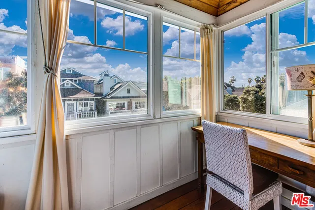 a view of a balcony with furniture and wooden floor