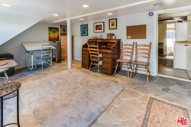 a view of a livingroom with furniture and workspace