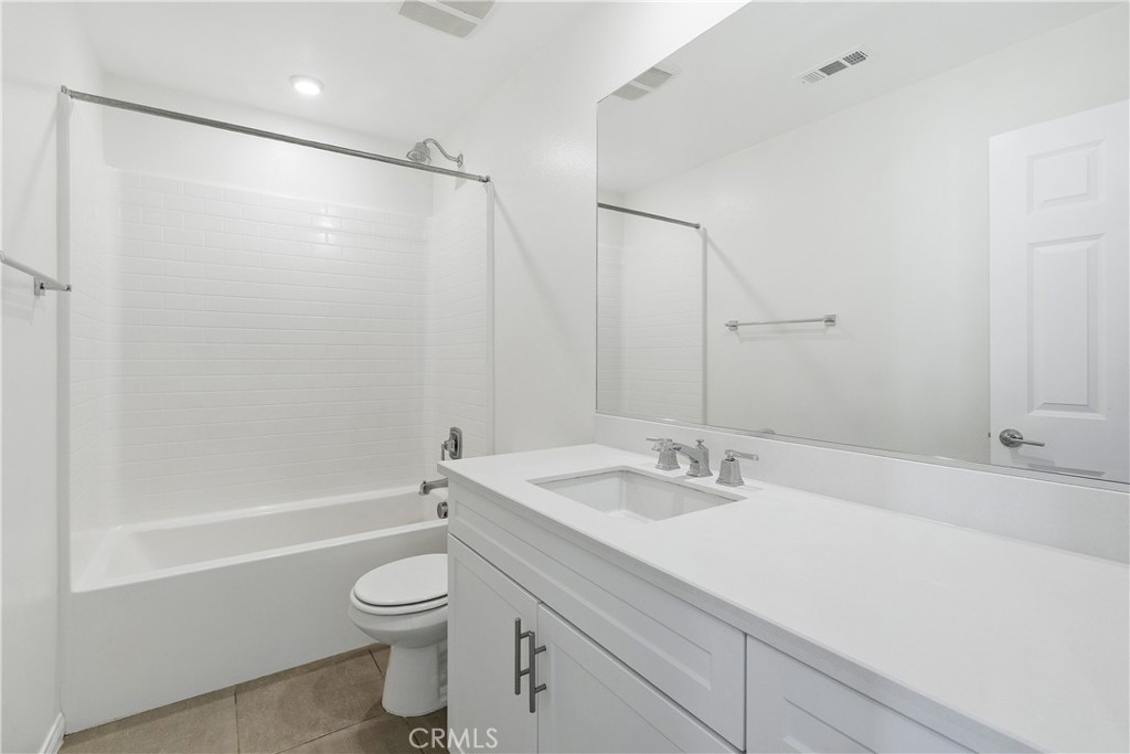 913 Helena Ridge Lake Elsinore, CA 92530 - Photo 28 of 38 a bathroom with a granite countertop sink toilet and shower
