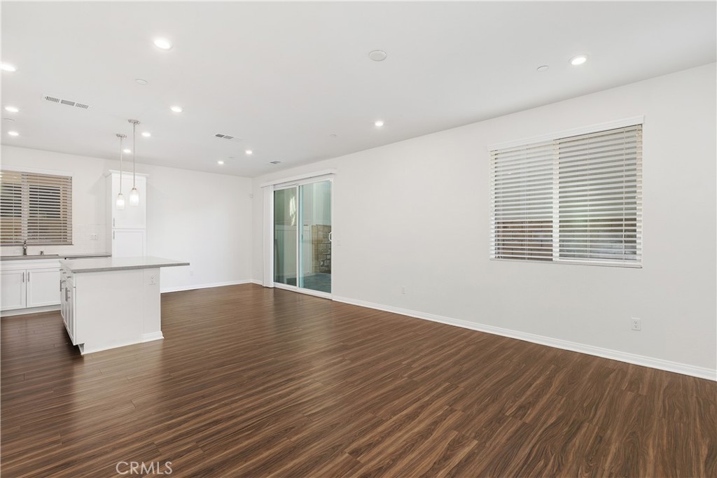913 Helena Ridge Lake Elsinore, CA 92530 - Photo 5 of 38 a view of an empty room with wooden floor and a window