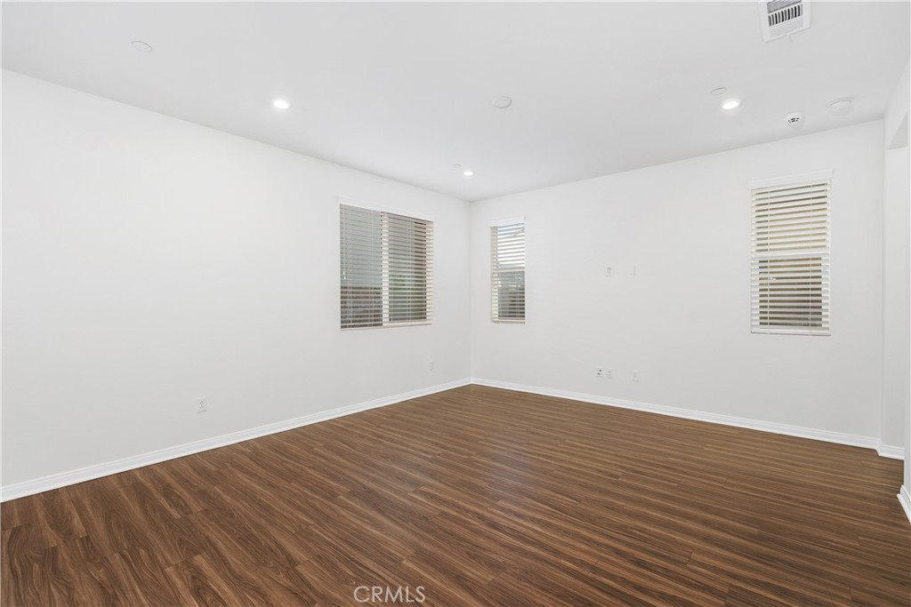 913 Helena Ridge Lake Elsinore, CA 92530 - Photo 6 of 38 a view of empty room with wooden floor and fan