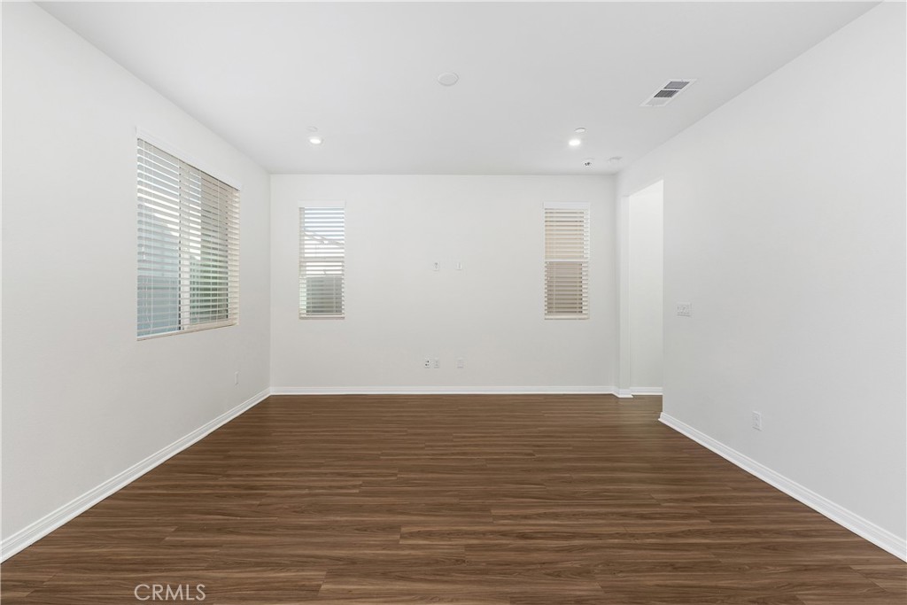 913 Helena Ridge Lake Elsinore, CA 92530 - Photo 7 of 38 a view of an empty room with wooden floor and a window