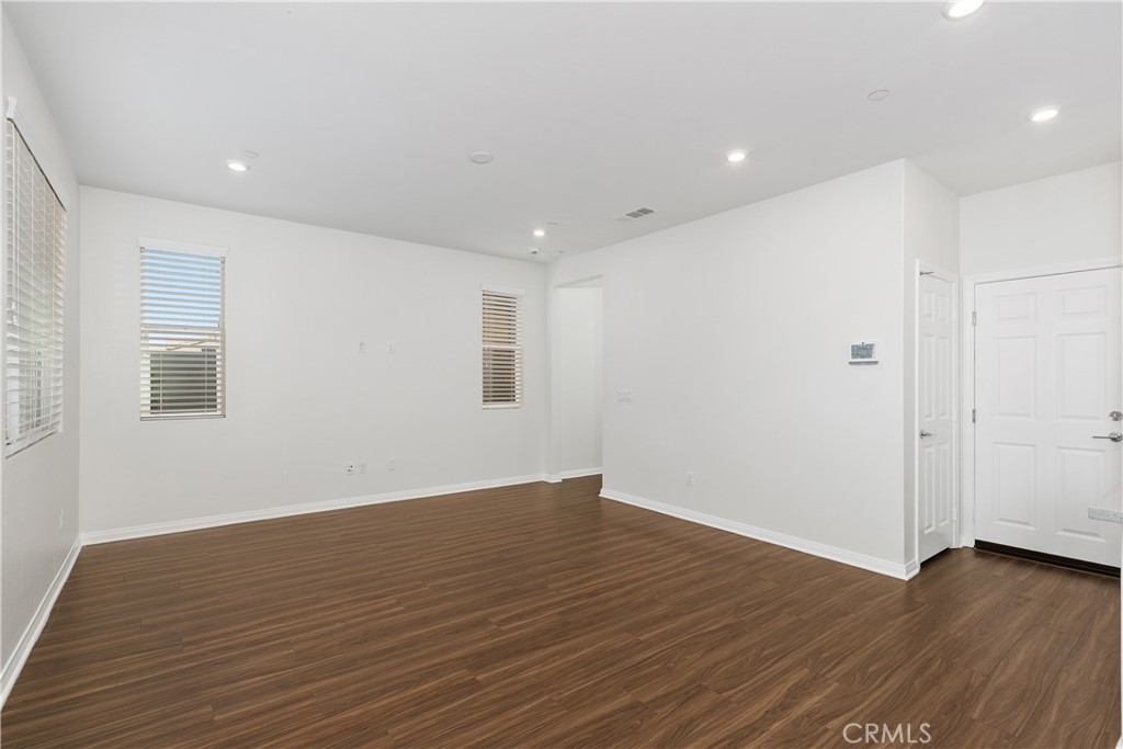 913 Helena Ridge Lake Elsinore, CA 92530 - Photo 8 of 38 a view of an empty room with wooden floor