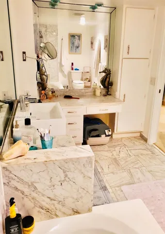 a bathroom with a tub sink and mirror