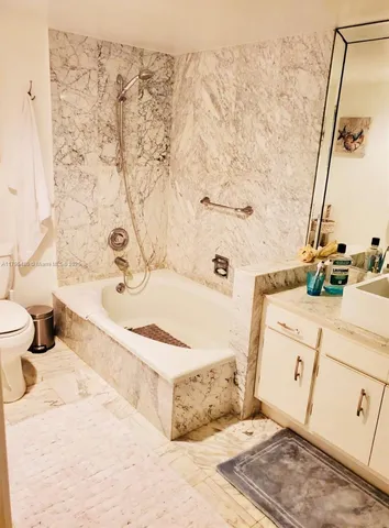 a large bed sitting in a bedroom next to a window