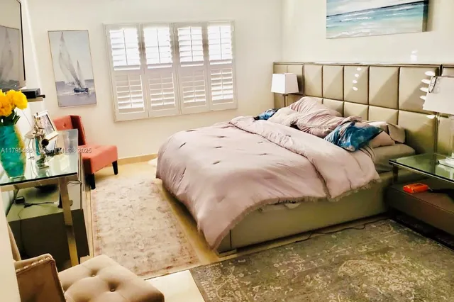 a bedroom with a bed and flat screen tv