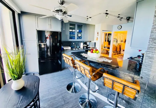 a kitchen with stainless steel appliances sink stove microwave and cabinets