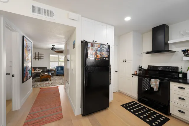 a kitchen with stainless steel appliances a counter space and cabinets