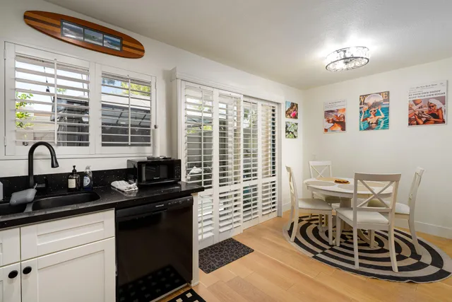 a bedroom with a bed a couch and painting on the wall