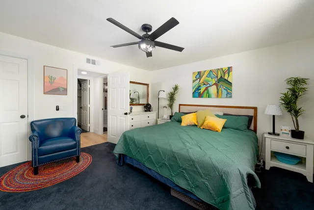 a bedroom with furniture and a flat screen tv