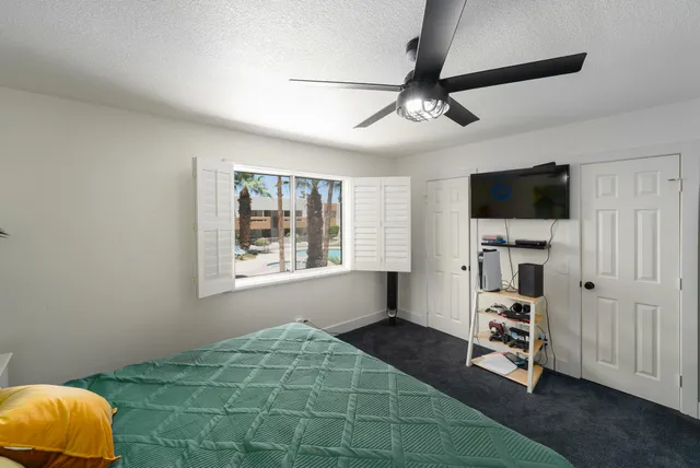 a bedroom with a bed and a tv