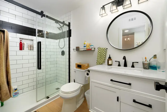 a view of a bedroom with bed and wooden floor
