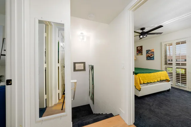 a bed sitting in a bedroom next to a window