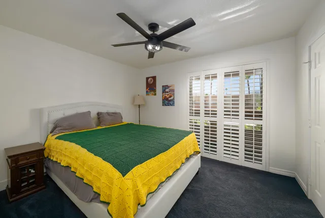 a bedroom with a bed and a television