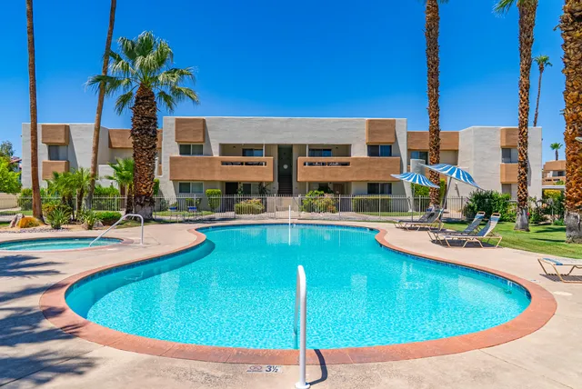 a view of a house with a small yard and plants