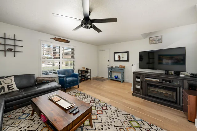 a living room with furniture a rug and a window