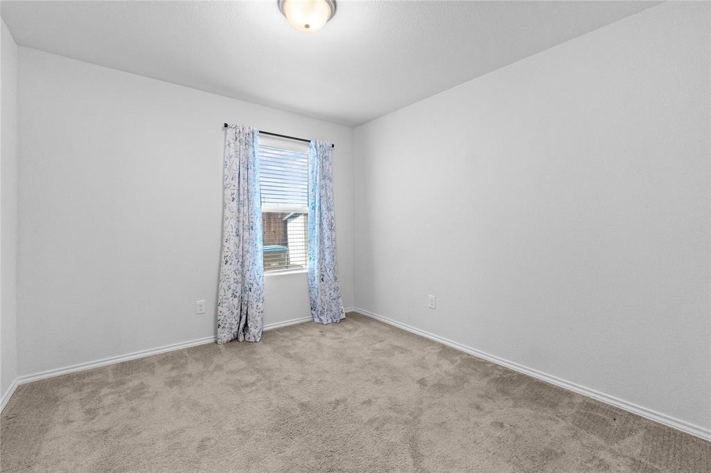 4432 Sagecroft Road Fort Worth, TX 76036 - Photo 11 of 16 Empty room featuring baseboards and light carpet