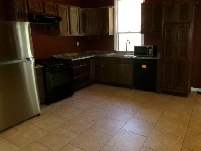 446 Merrick Street Shreveport, LA 71104 - Photo 15 of 16 a kitchen with a sink a stove and refrigerator